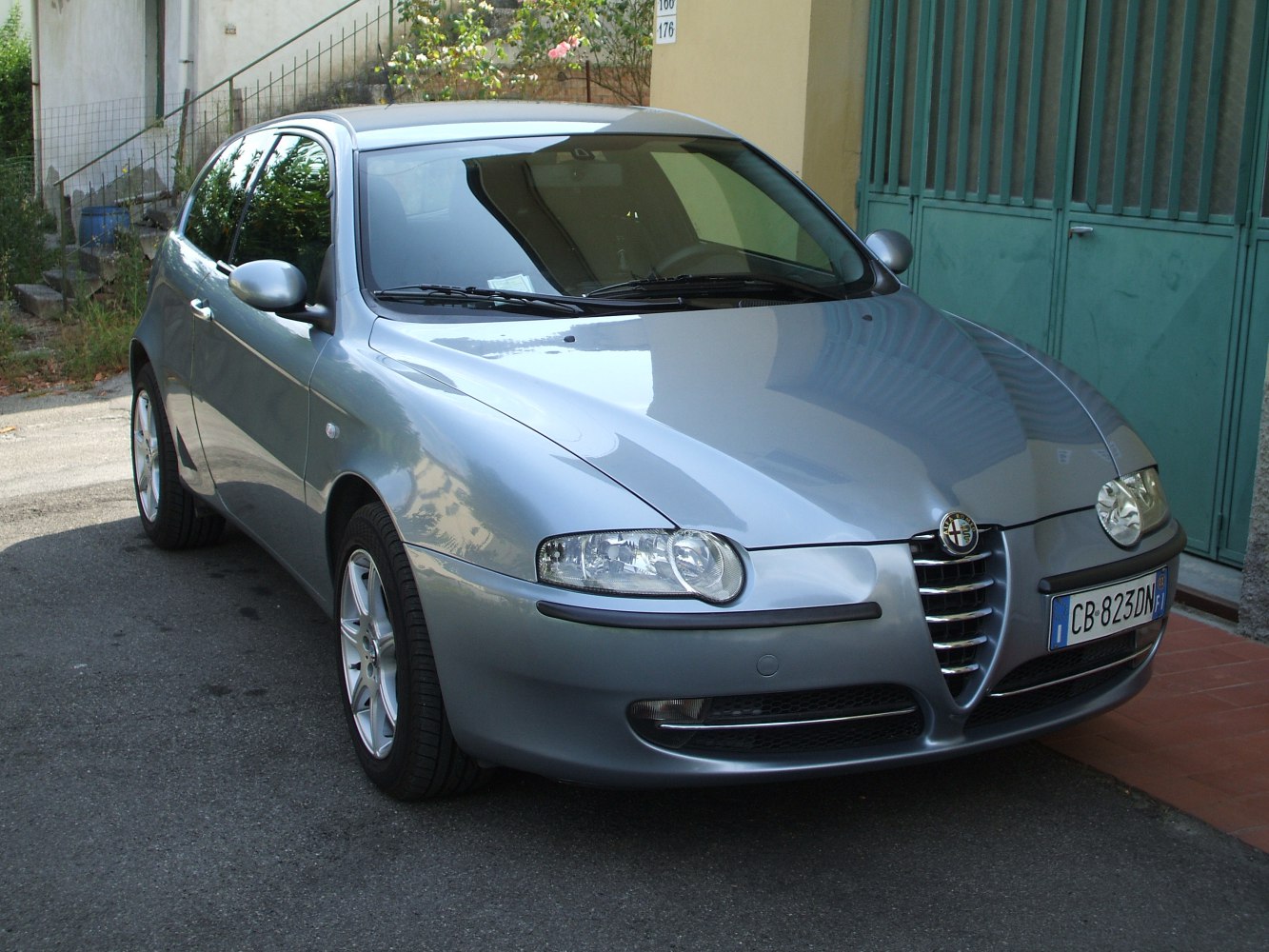 Side-front view of 3-door hatchback with dual headlights and sleek body lines