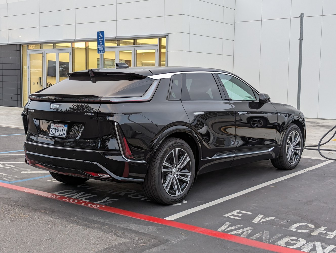 Sleek black SUV rear side with modern taillights and charging port
