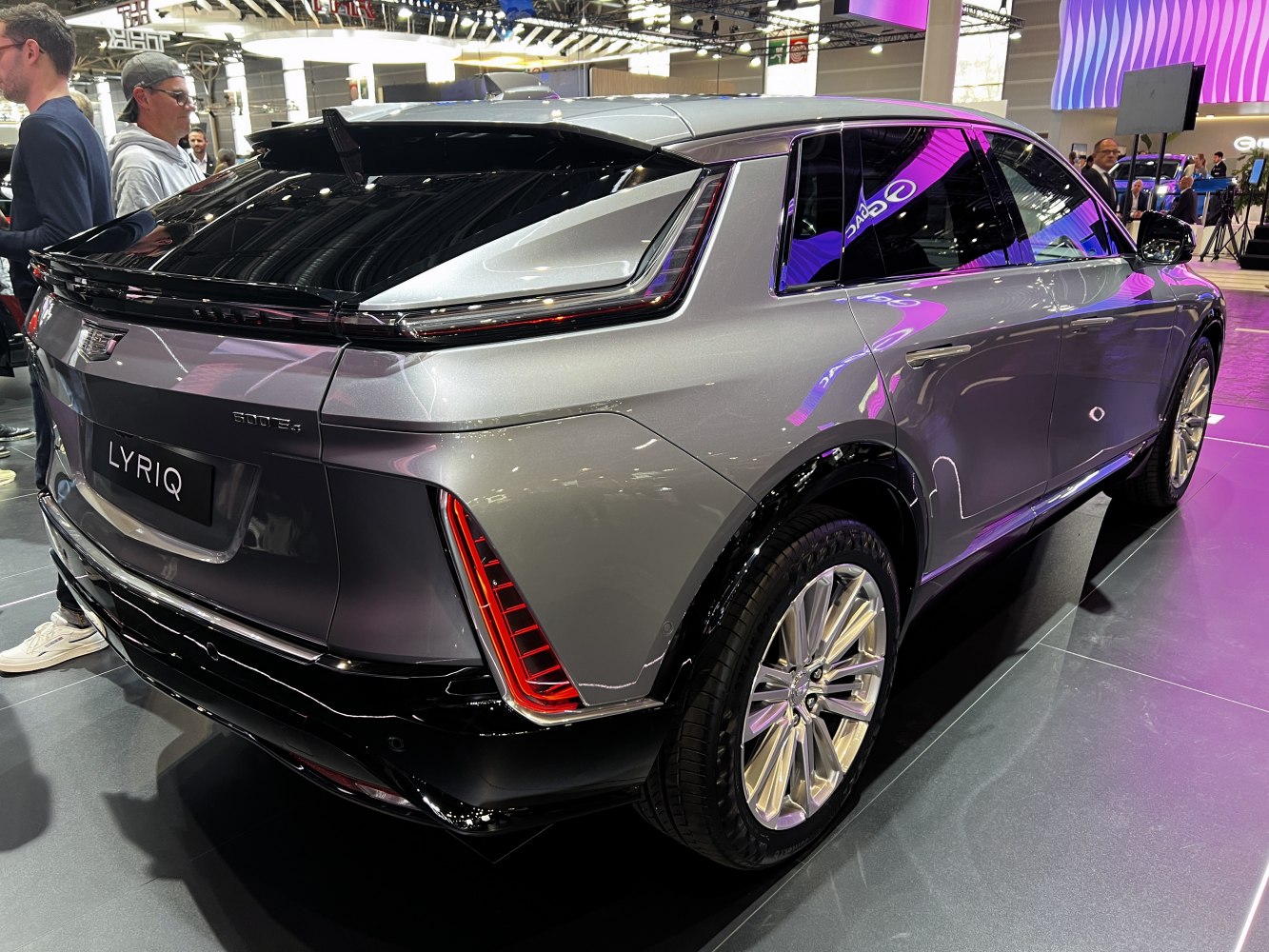 Rear-side view of a silver electric SUV with distinctive LED taillights