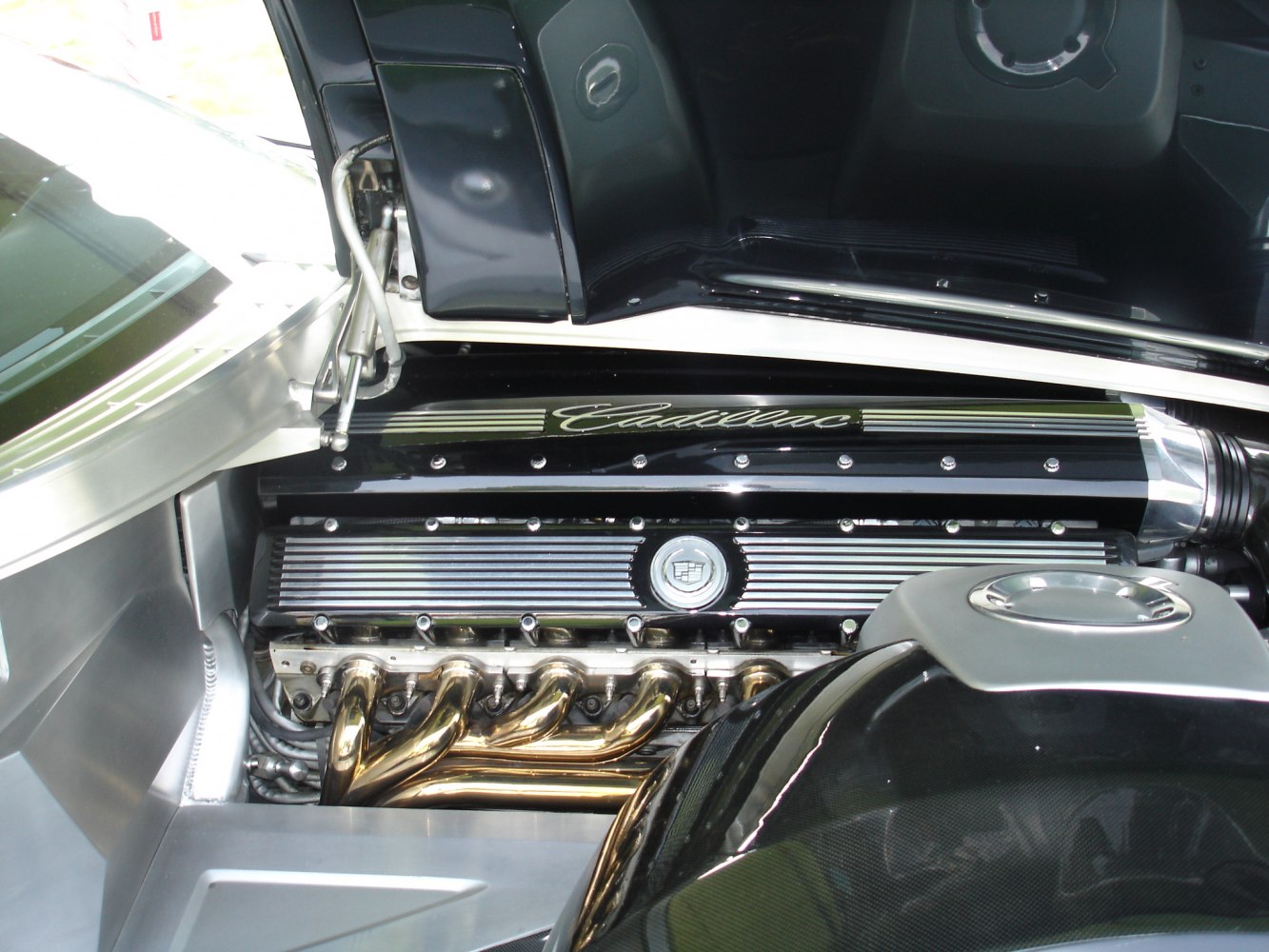 V16 engine with chrome exhaust headers and detailed compartment