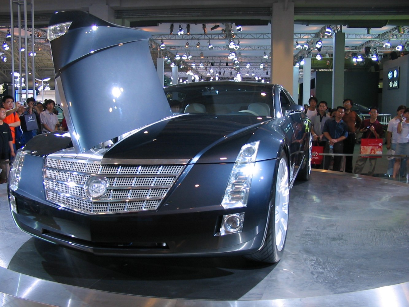 Luxury car front with open hood and distinctive grille