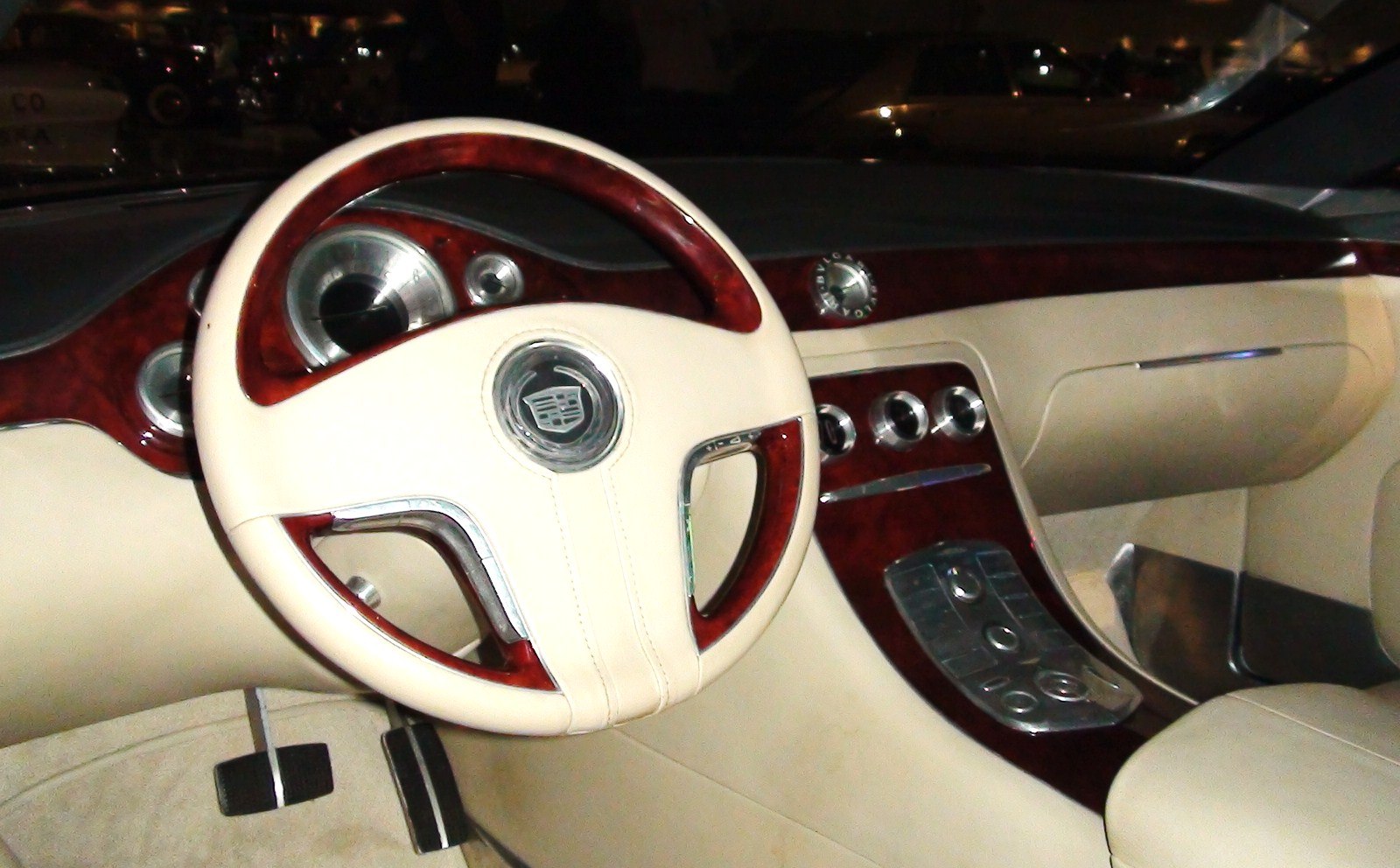 Wood-trimmed steering wheel and dashboard with beige leather upholstery