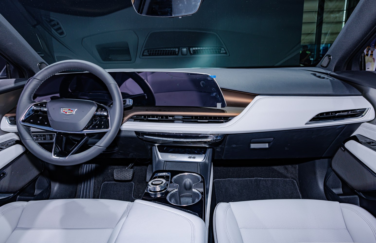 Digital dashboard and sleek steering wheel with white leather seats