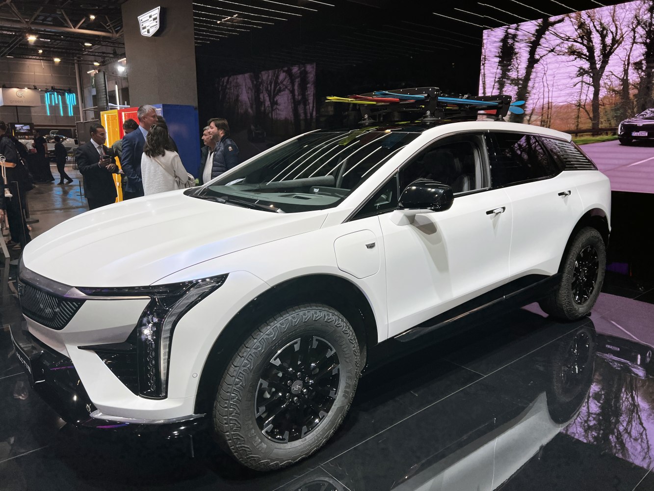 Modern electric SUV with roof rack and rugged off-road tires