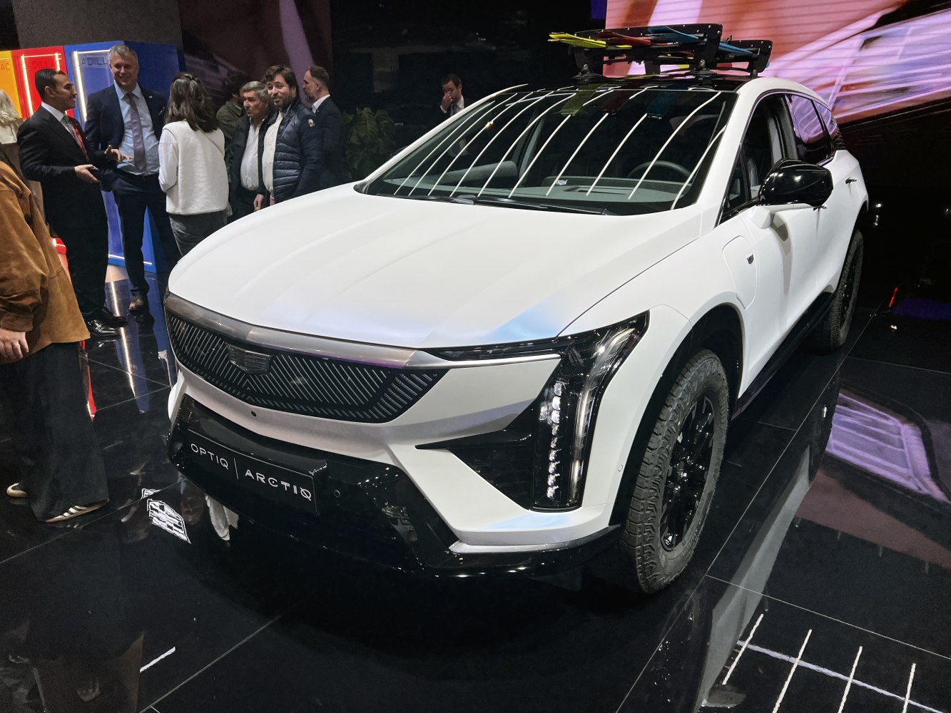 Front view of white SUV with LED headlights and roof rack