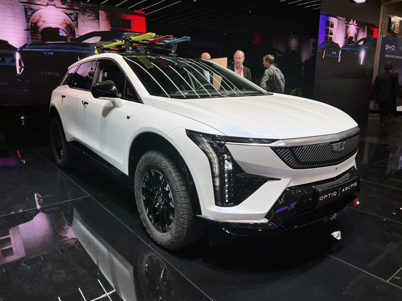 Electric SUV with rugged tires and colorful roof rack