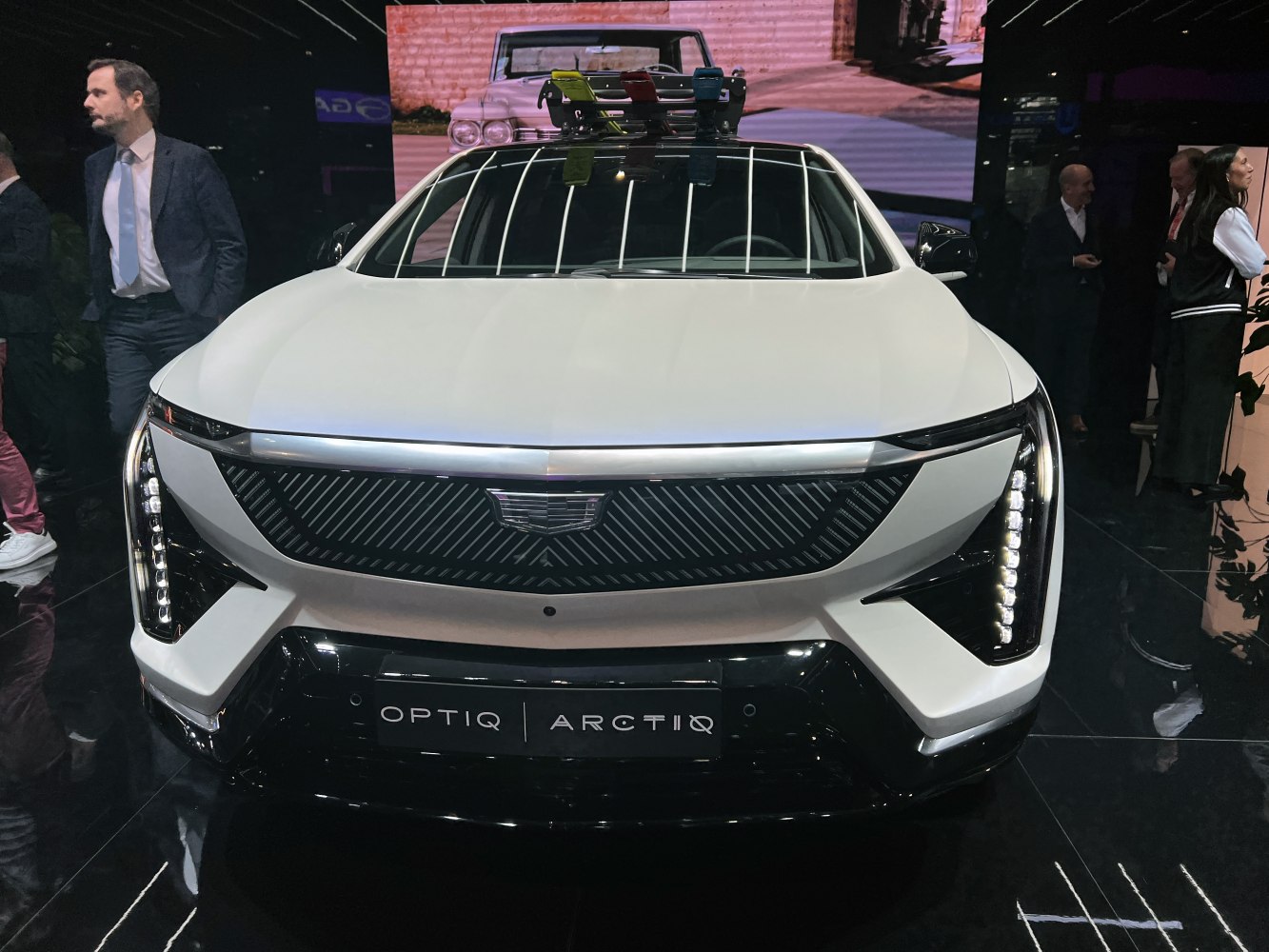 Front view of a sleek car with vertical LED headlights and modern grille