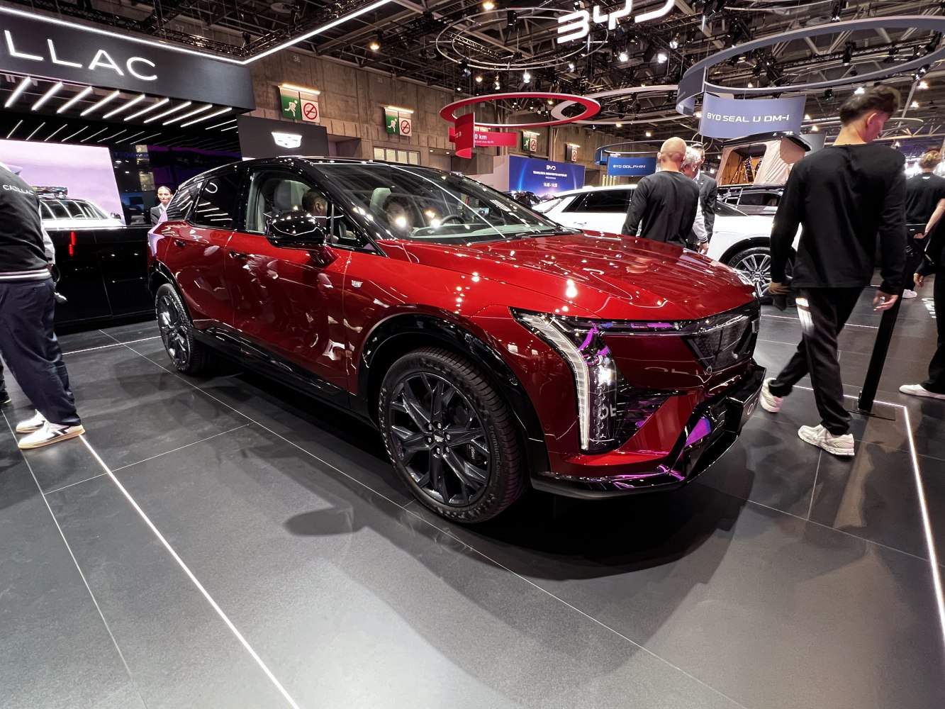 Red electric SUV with angular LED headlights and black wheels