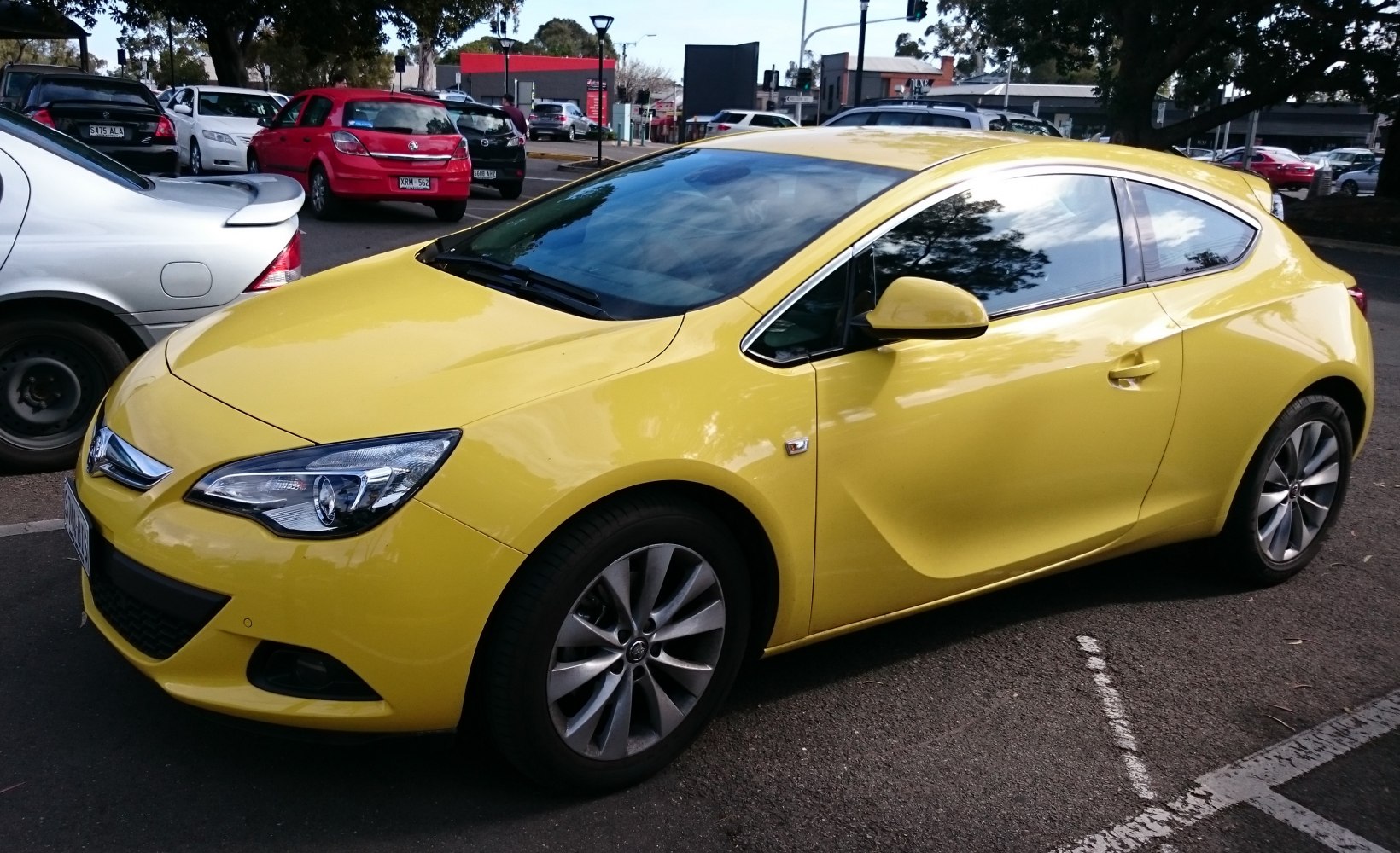 Yellow compact hatchback with stylish headlights and alloy wheels