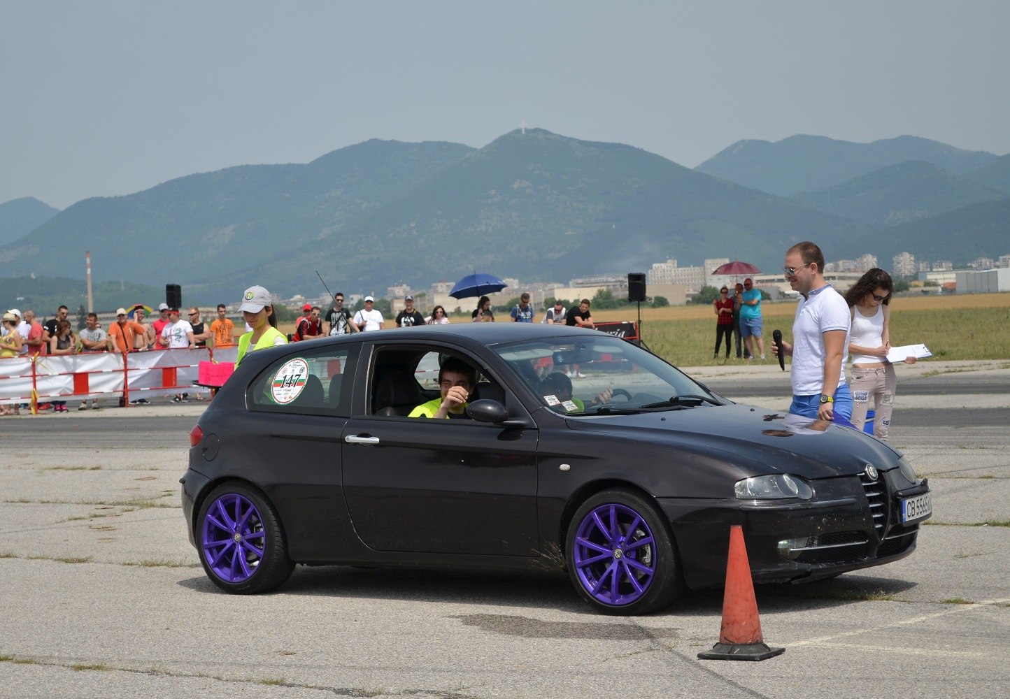 Black 3-door hatchback with purple alloy wheels