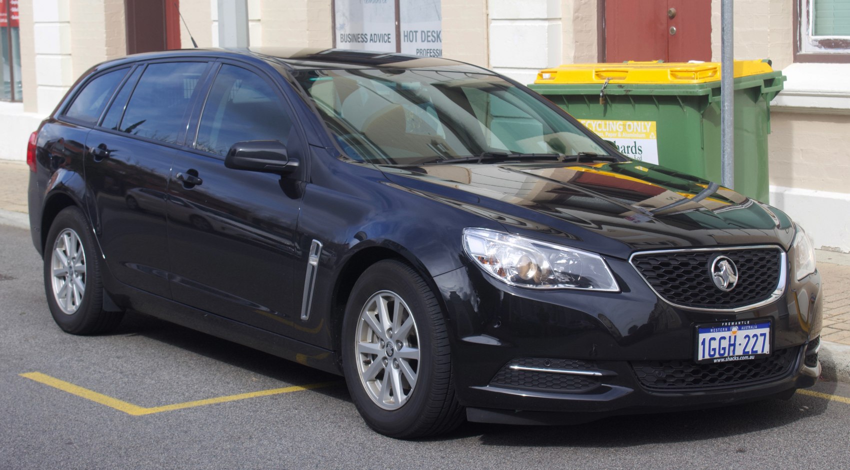 Black wagon with alloy wheels and modern headlights.