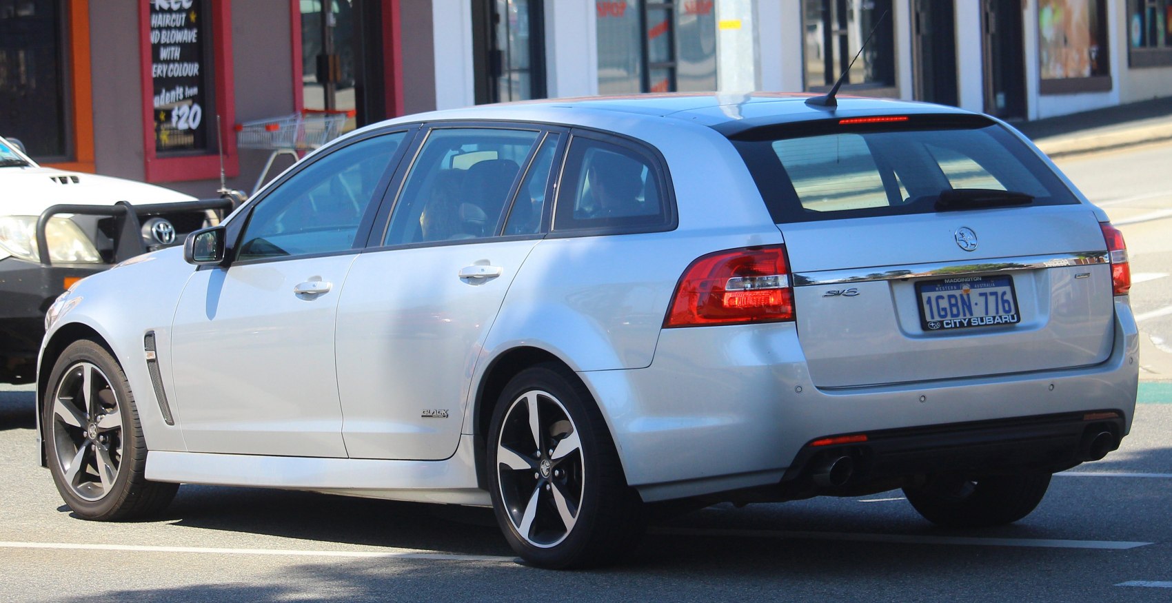 Rear side profile of a modern silver sportwagon with alloy wheels