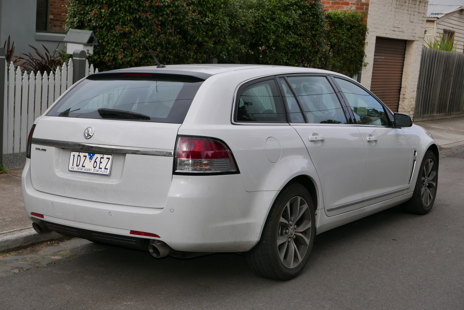 Rear view of white station wagon with dual exhaust and tinted windows