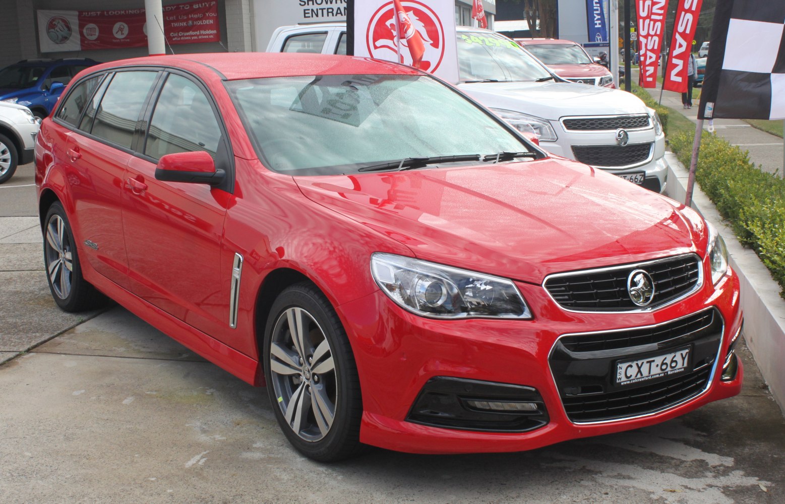Red sports wagon with modern headlights and alloy wheels