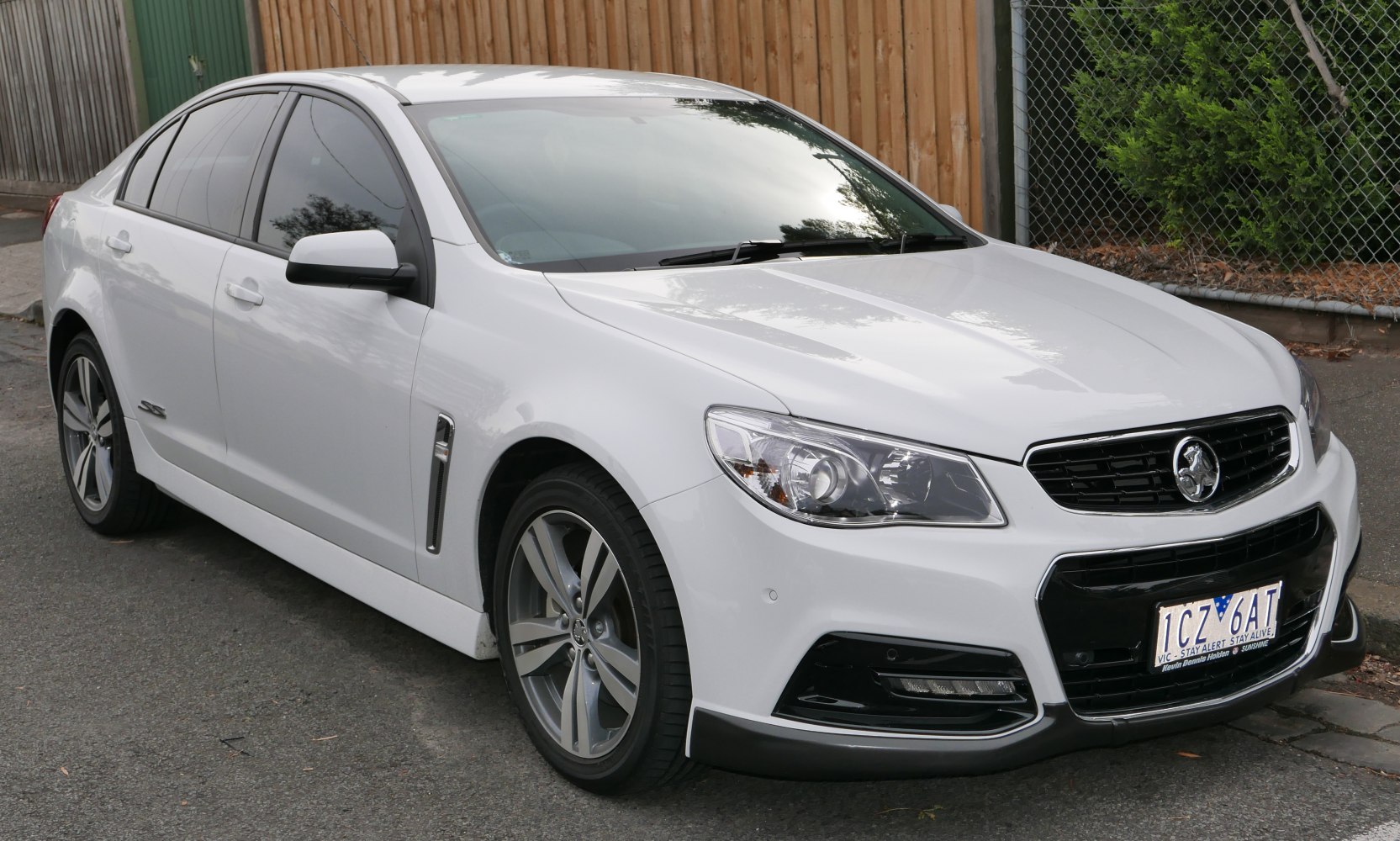 Front view of a white sedan with alloy wheels and distinctive grille