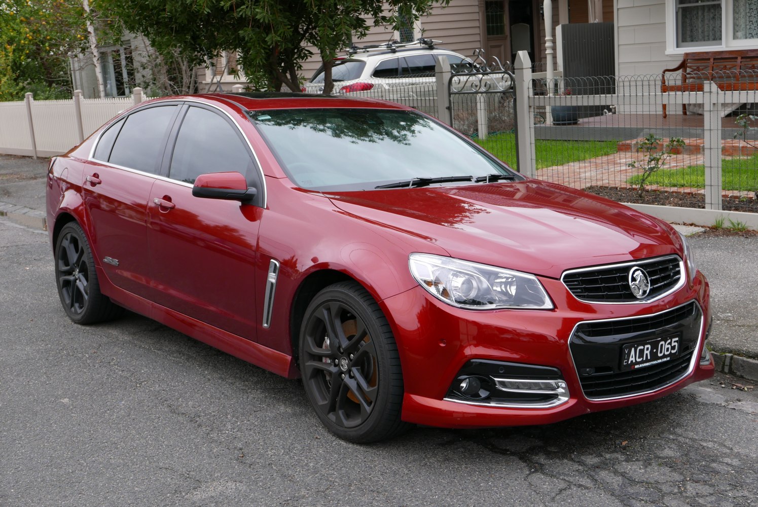 Red sedan with black alloy wheels and chrome trim
