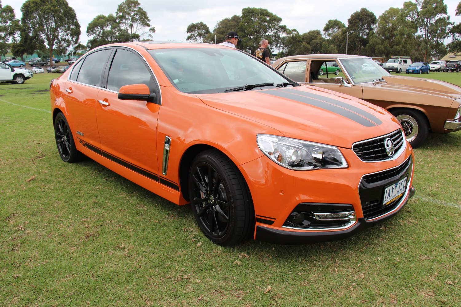 Bright orange sedan with black stripes and sporty black alloy wheels