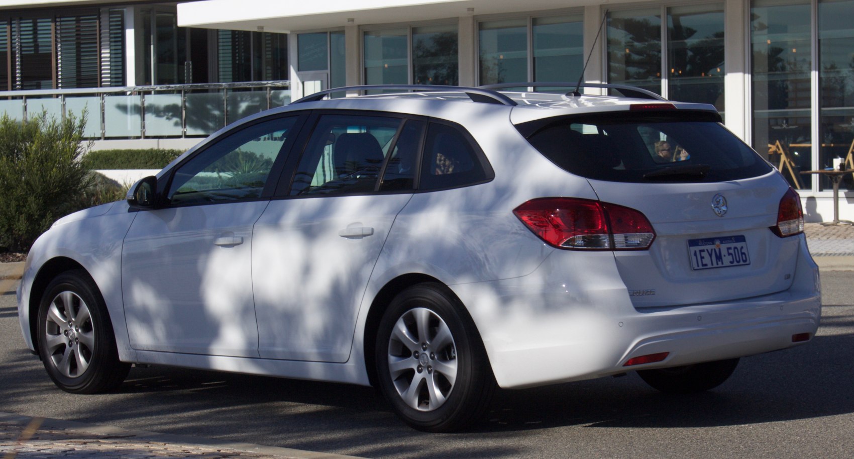 Rear and side view of a hatchback wagon with alloy wheels and roof rails