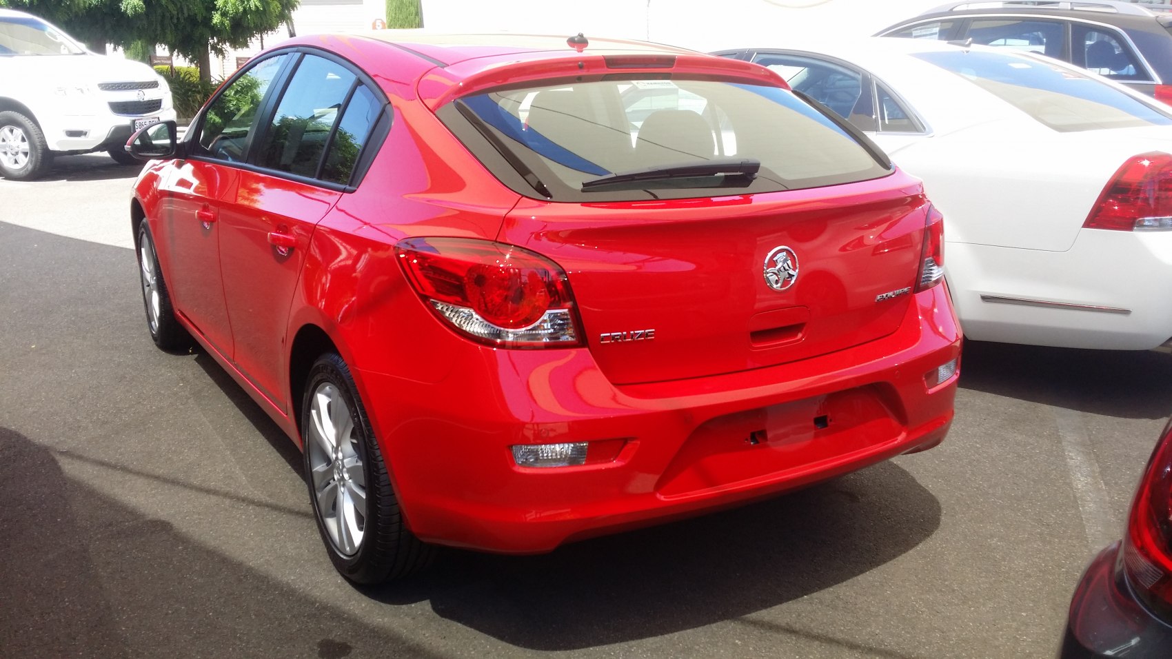 Red five-door hatchback showing rear design and taillights