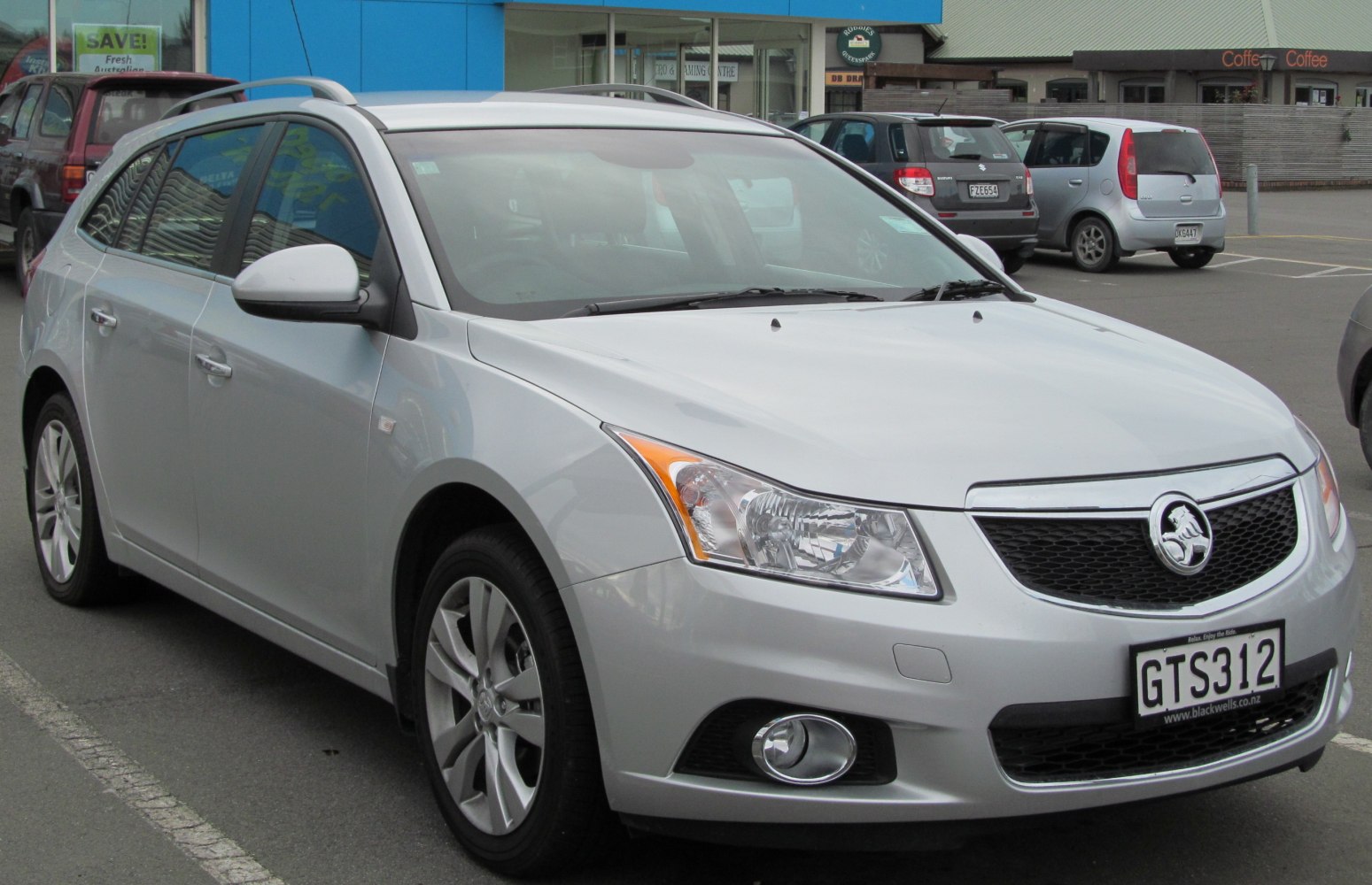 Front-side view of a silver station wagon with alloy wheels and fog lights