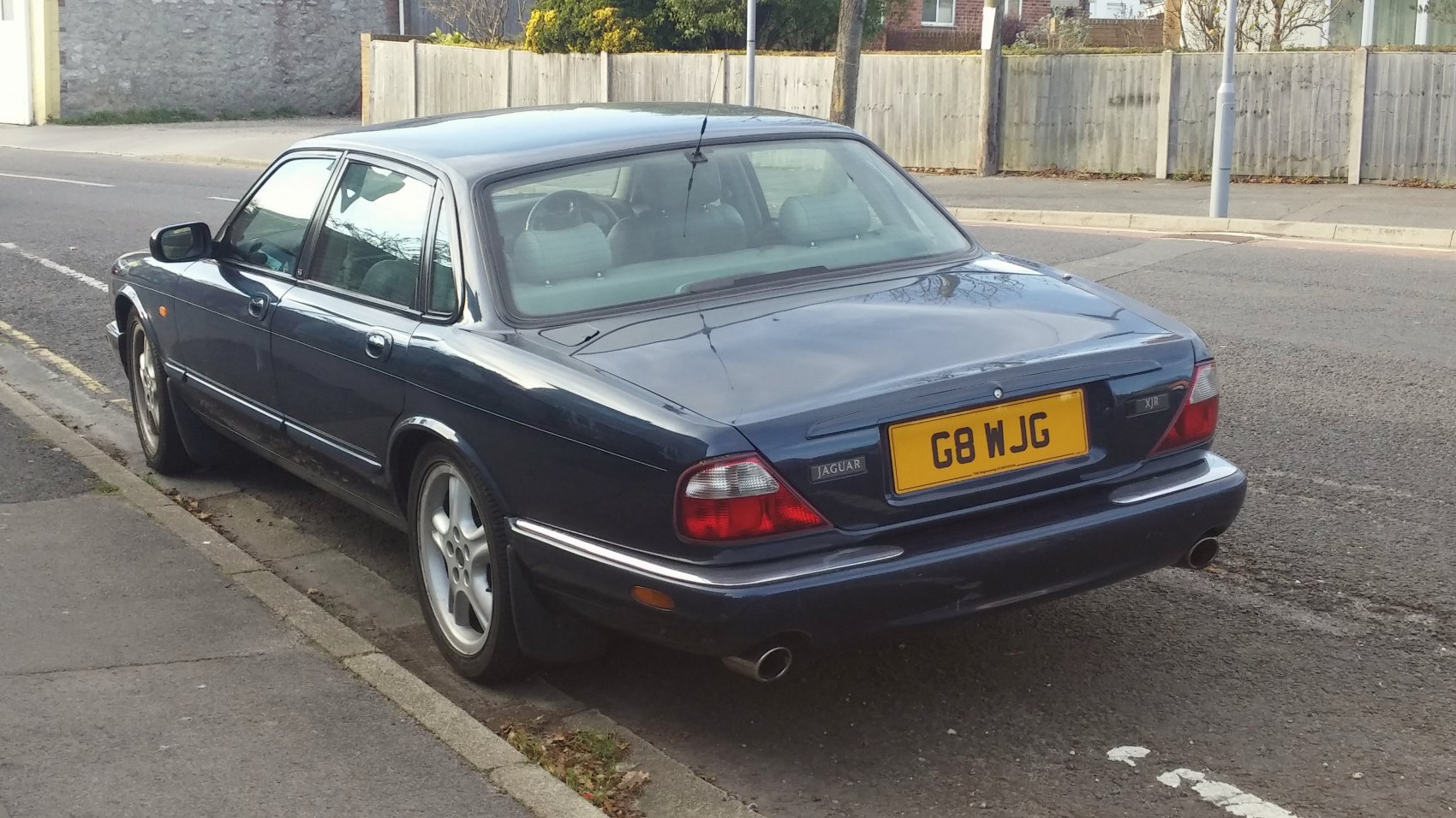Rear view of a luxury sedan with distinct tail lights and dual exhaust
