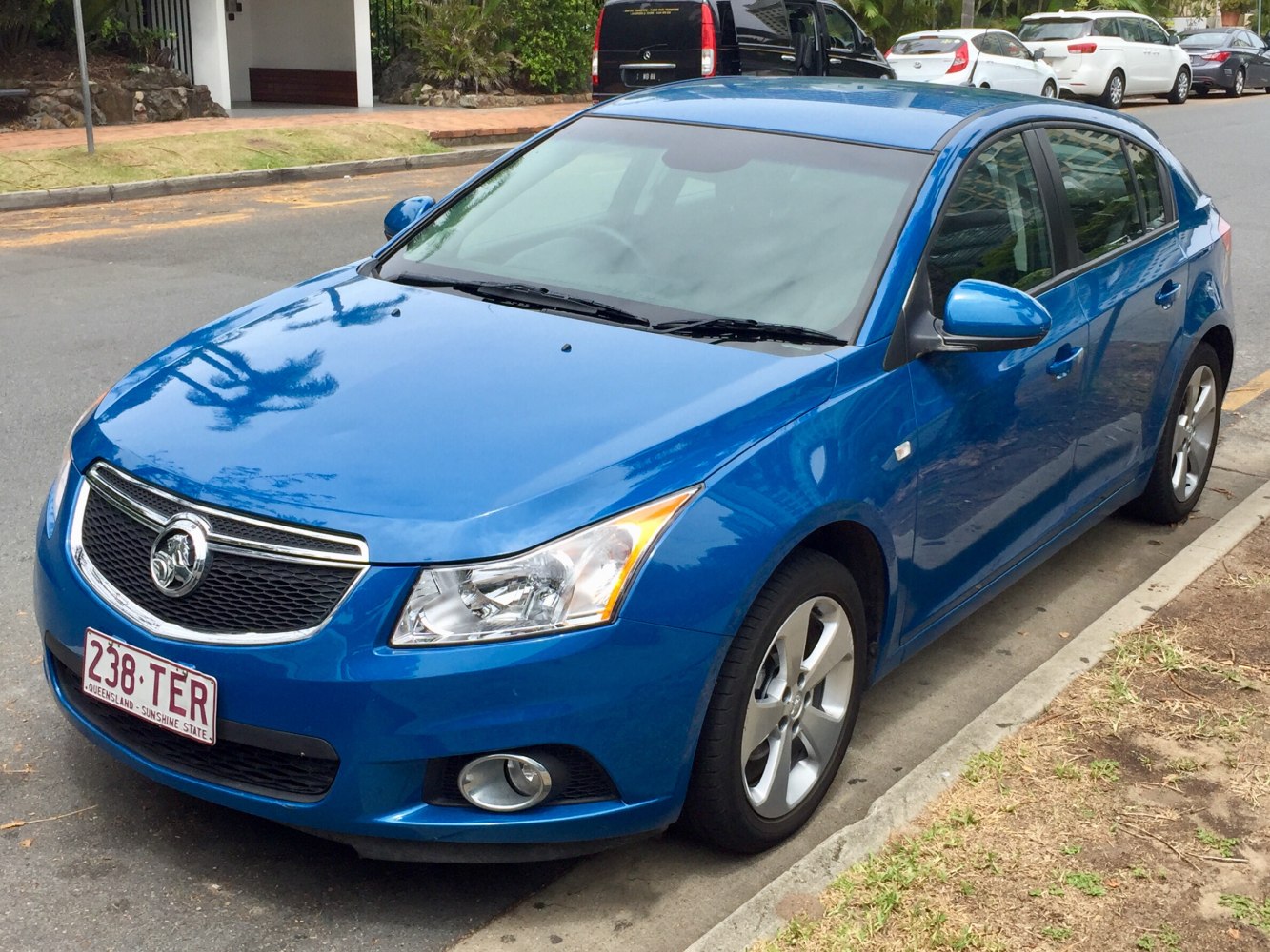 Front-side view of blue compact hatchback with alloy wheels