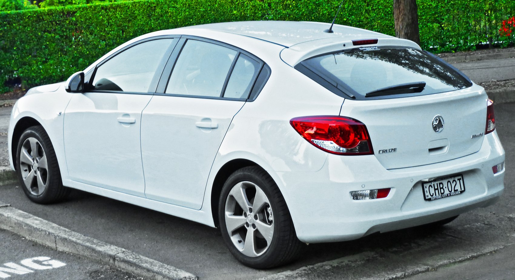 Rear side view of white hatchback with alloy wheels and sleek design