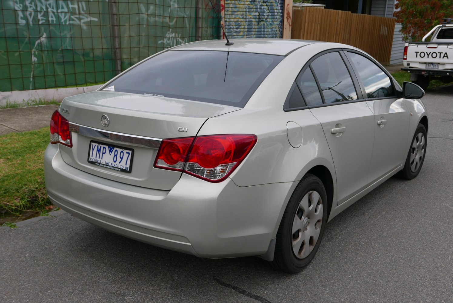 Rear side view with distinct taillights and trunk design of a compact sedan.