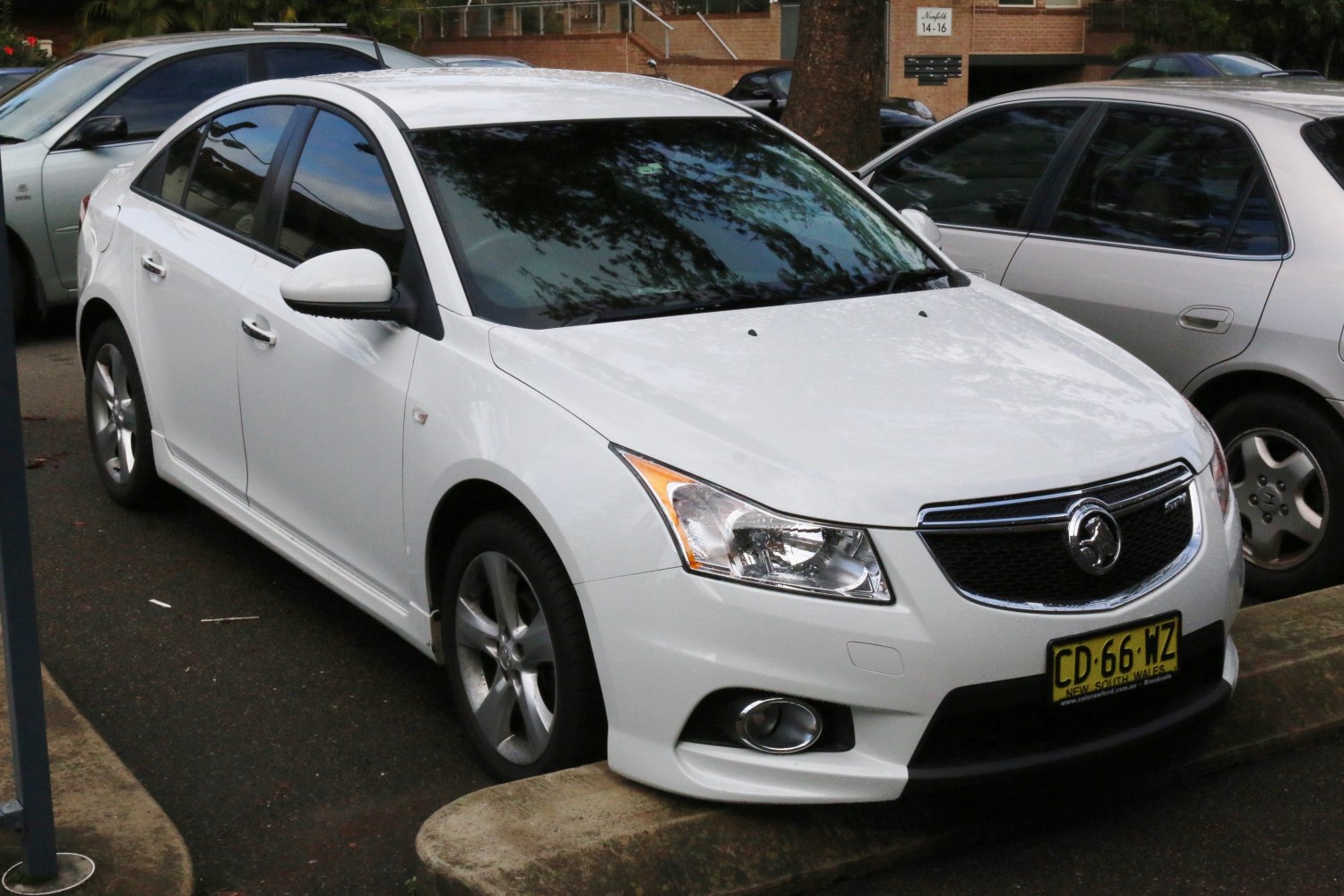 White sedan with angular headlights and chrome grille trim