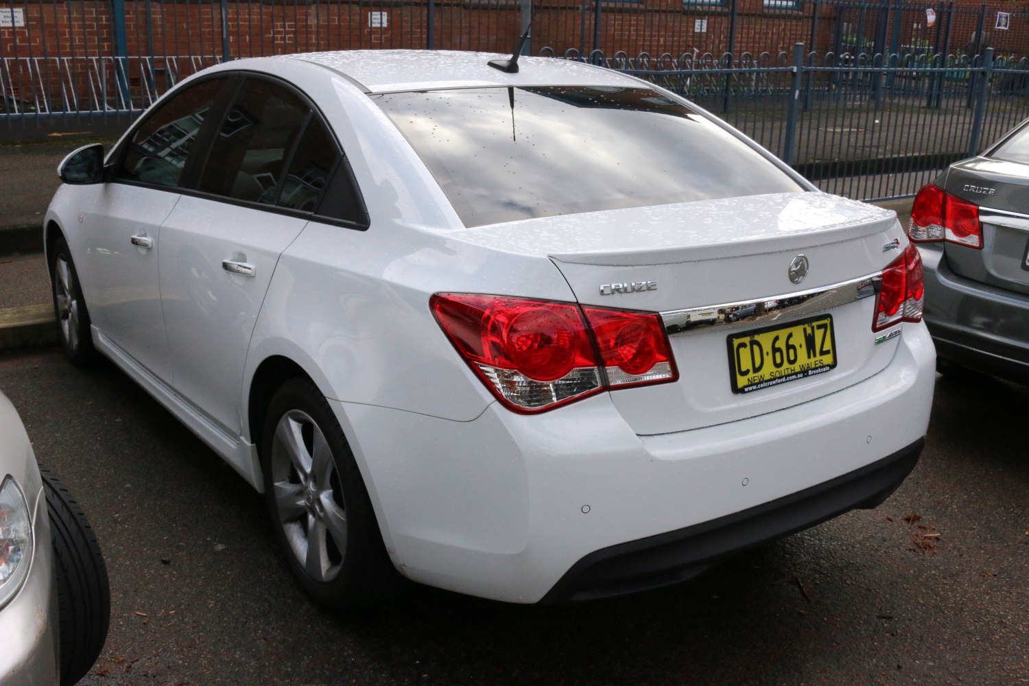 Rear view showing tail lights and rear spoiler of a mid-size sedan