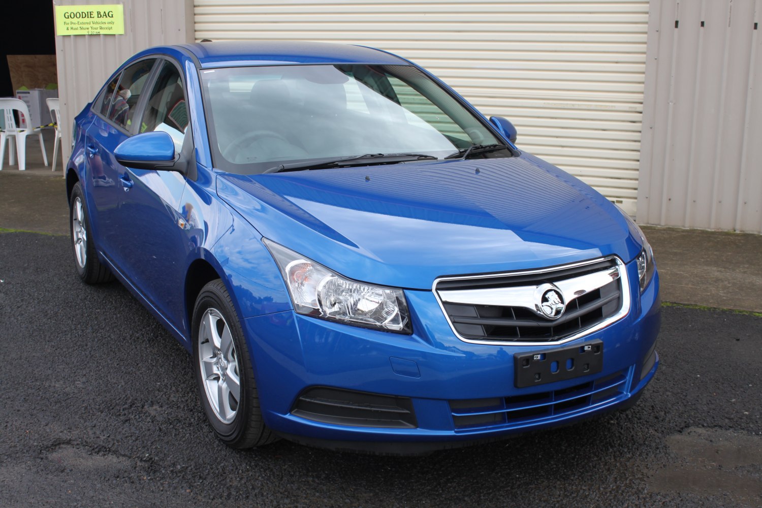 Front three-quarter view of blue sedan with distinct headlights and chrome grille