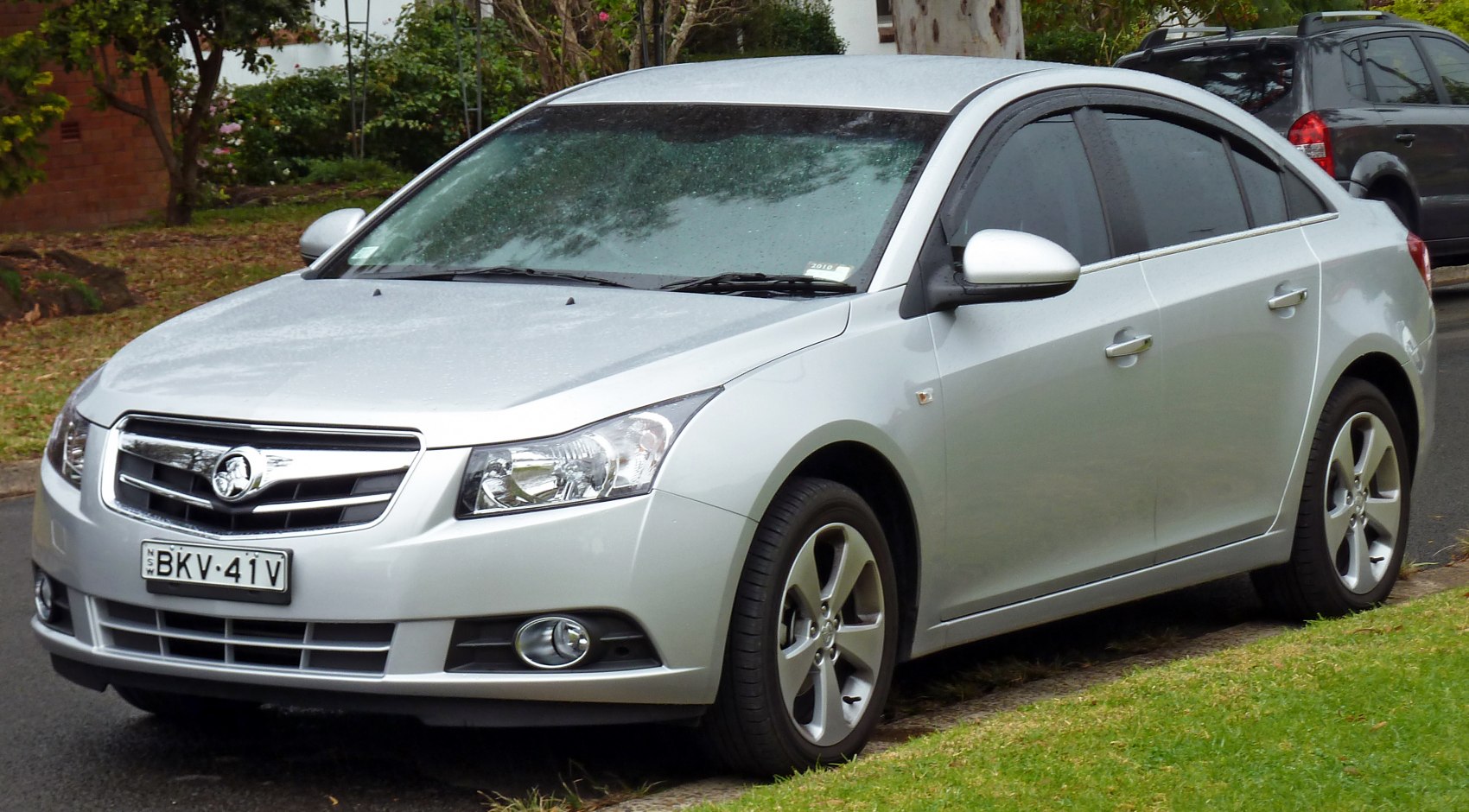 Front and side exterior view of a mid-size sedan with alloy wheels and fog lights
