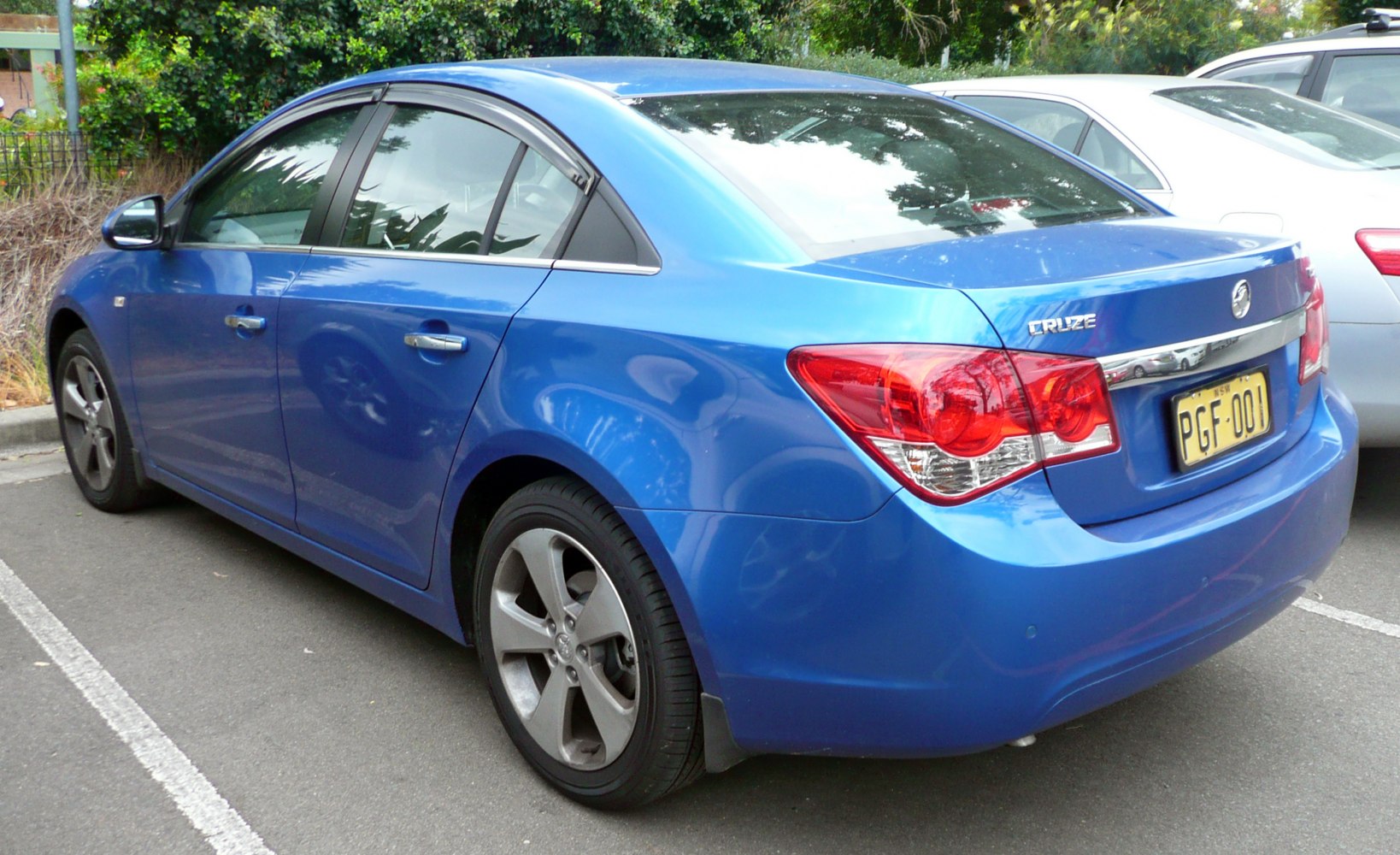 Rear view of blue sedan with distinctive tail lights and sleek body lines