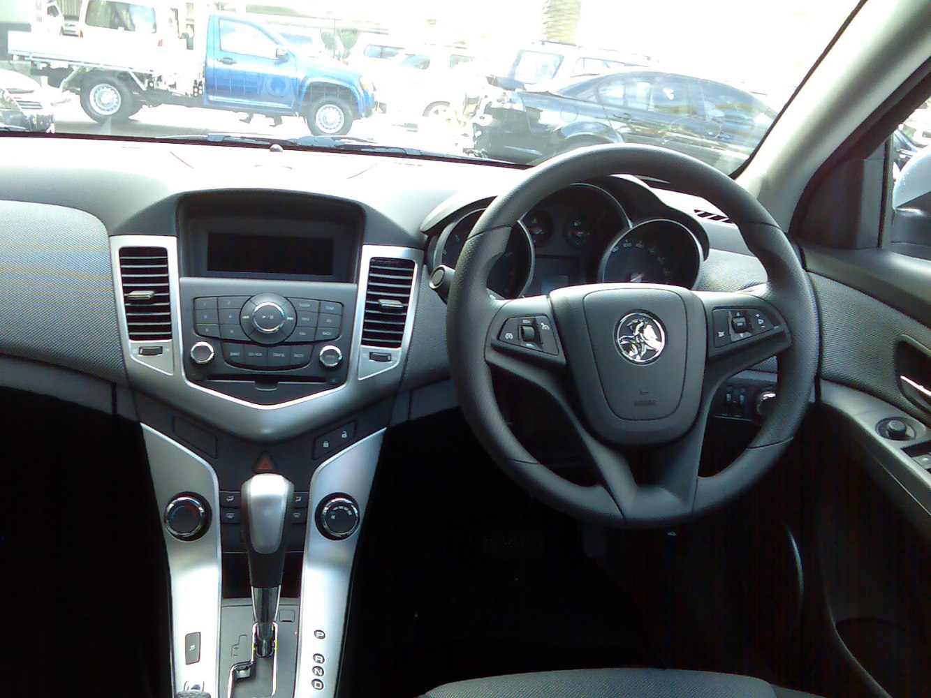 Dashboard and steering wheel with infotainment controls and automatic gear shift