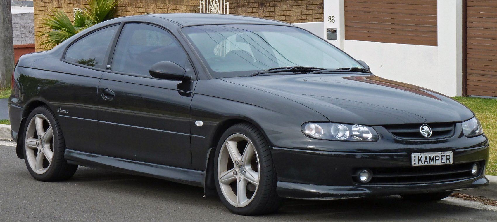 Black two-door coupe with alloy wheels and dual headlights