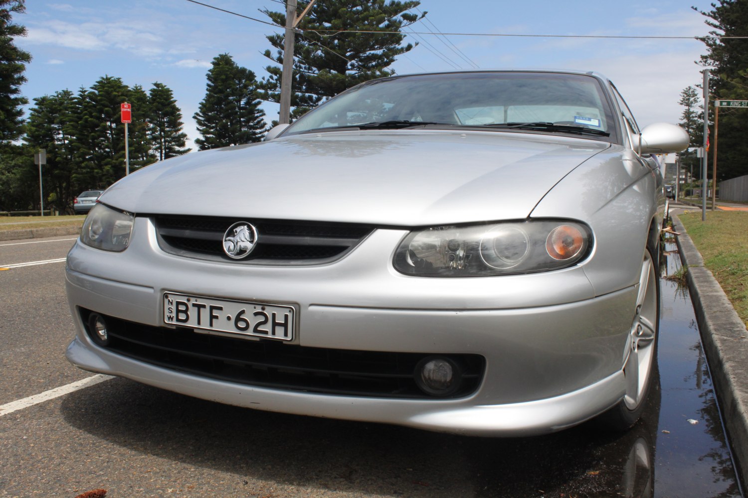 Close-up of car front with grille badge and dual headlights