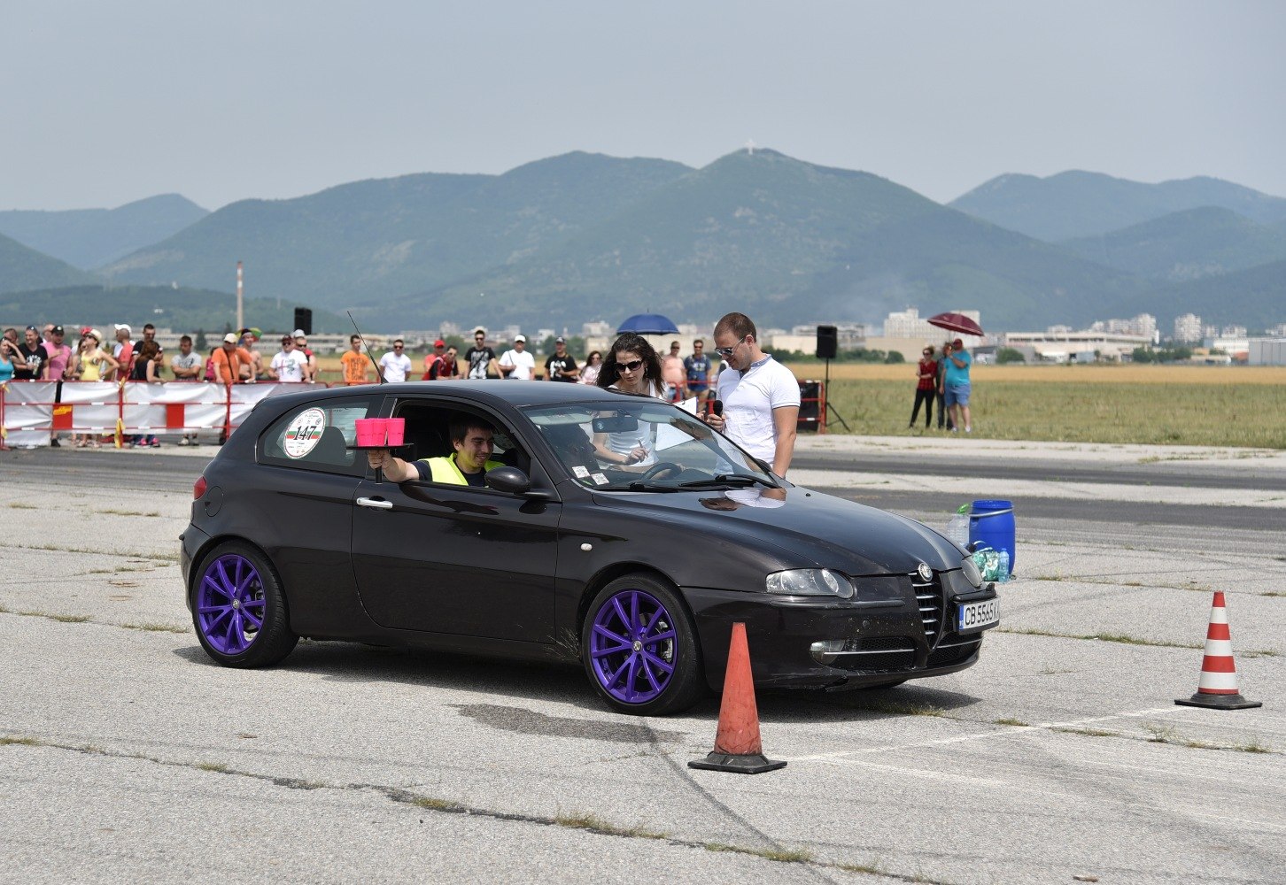 Black 3-door hatchback with purple alloy wheels