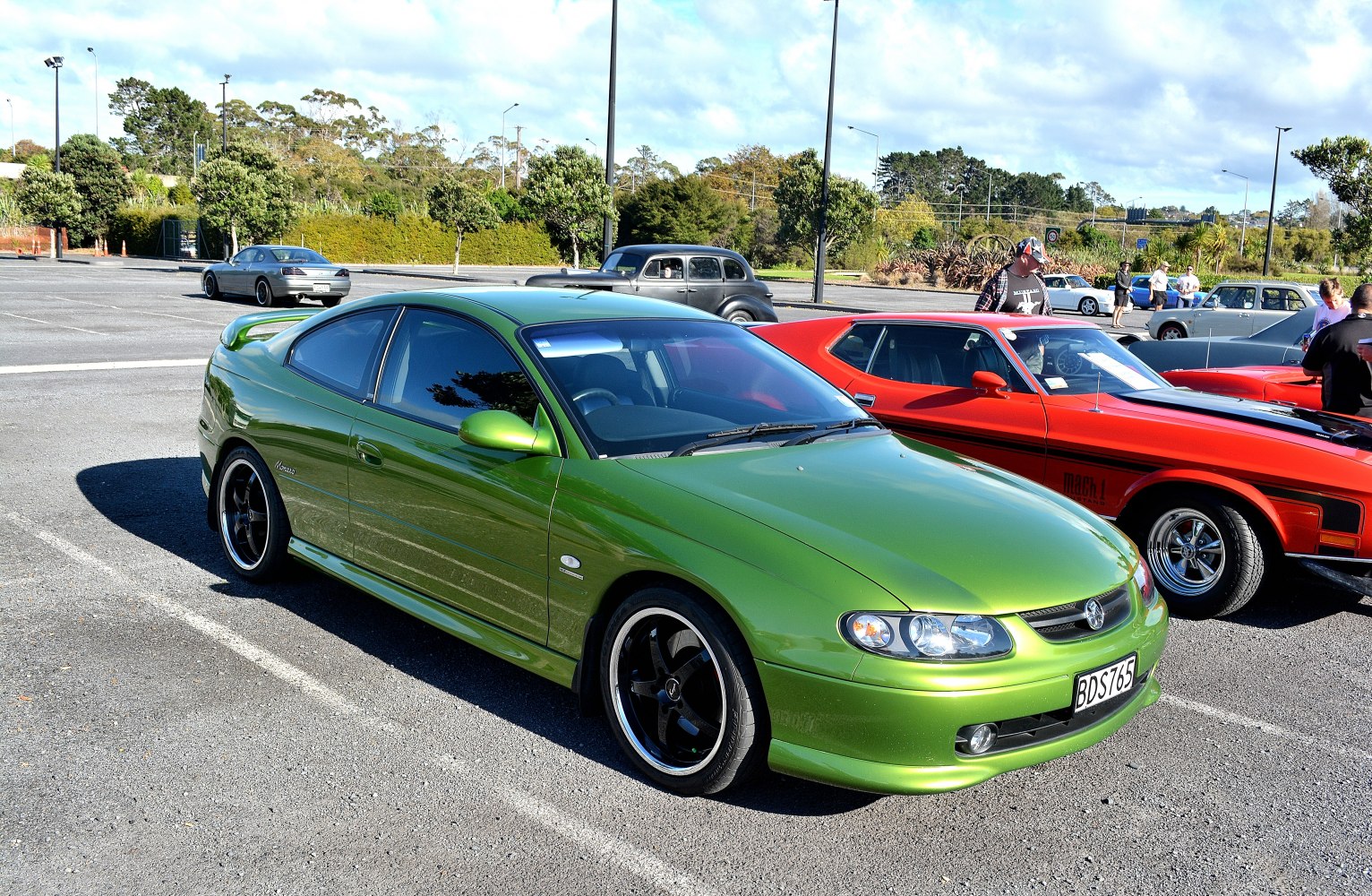 Green sports coupe with alloy wheels and rear spoiler