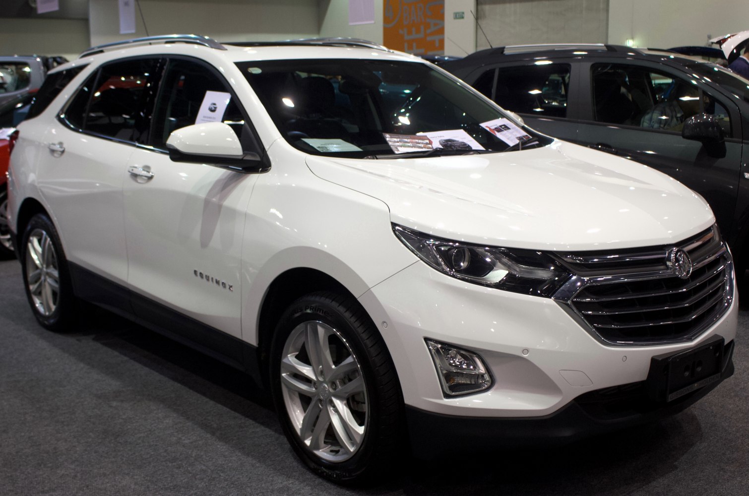 LED headlights, chrome grille, alloy wheels on white SUV
