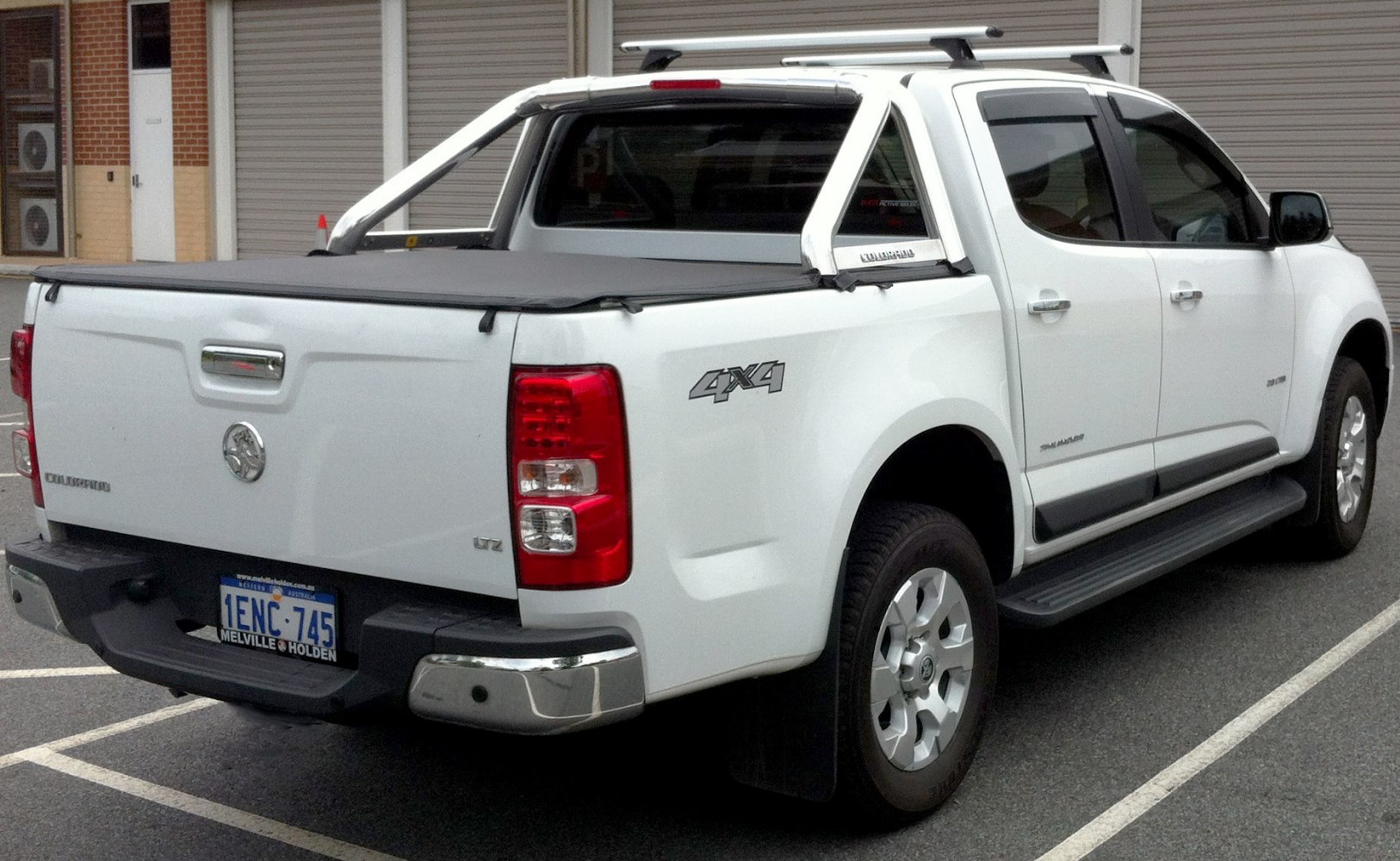 Rear side of pickup with soft tonneau cover and chrome roof rails