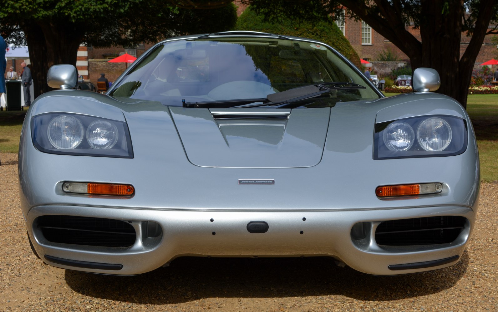 Front view with dual round headlights and large air intakes.