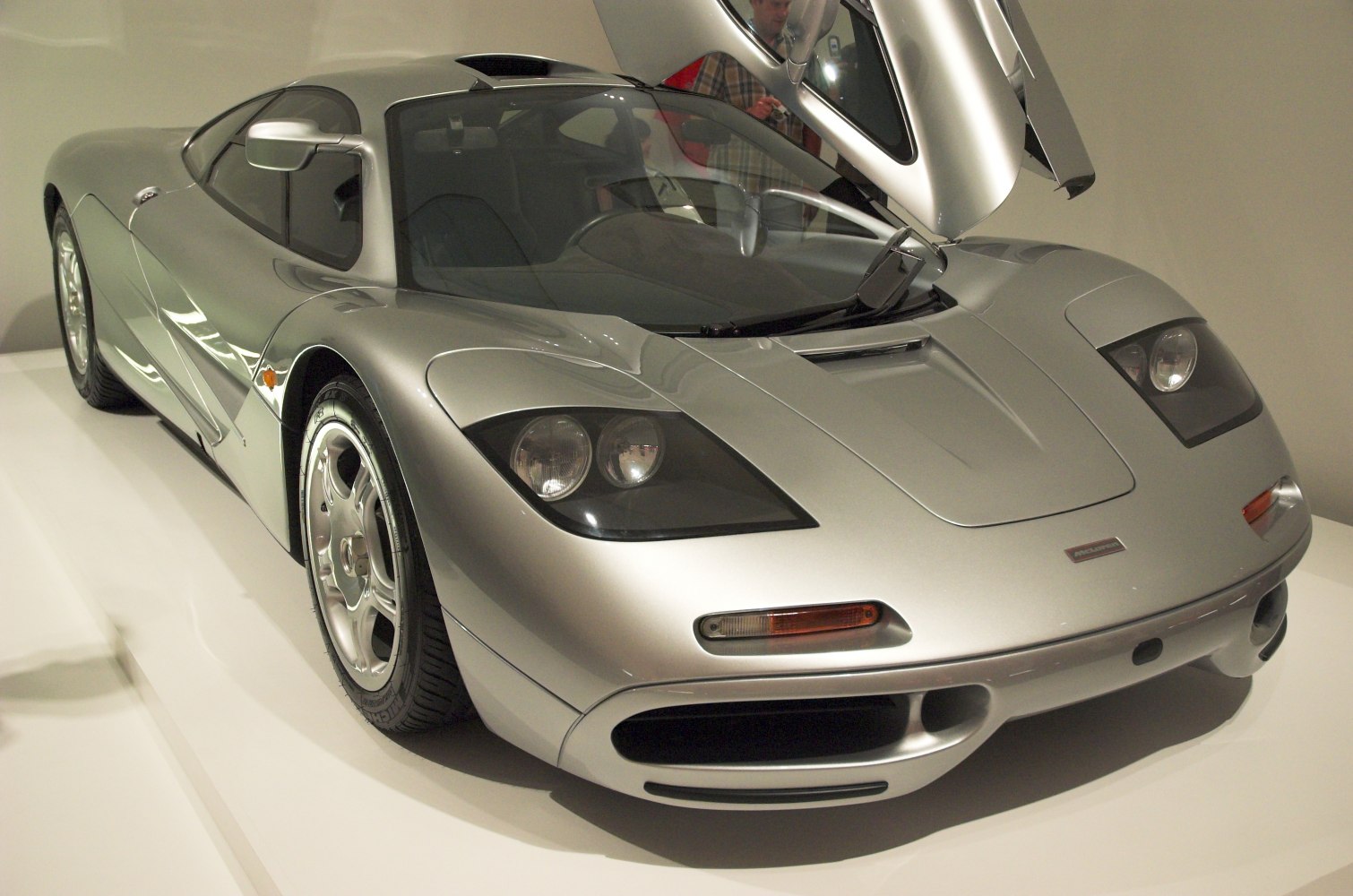 Silver supercar with gullwing door and aerodynamic front design