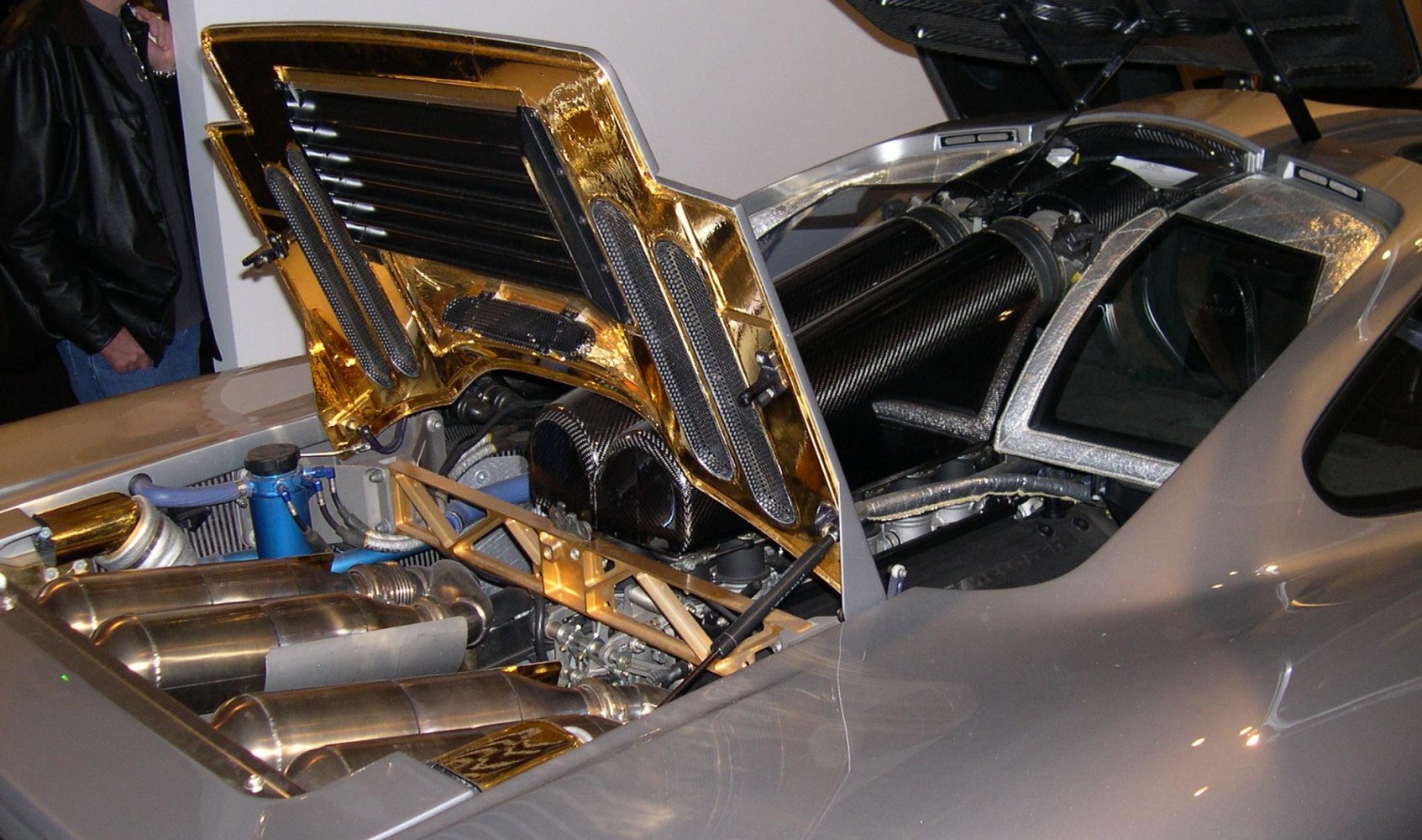 High-performance engine bay with carbon fiber intake tubes and gold heat shielding