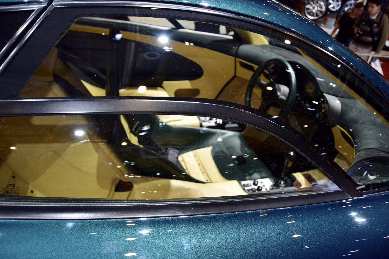 Three-seat sports car interior with central driver and beige upholstery