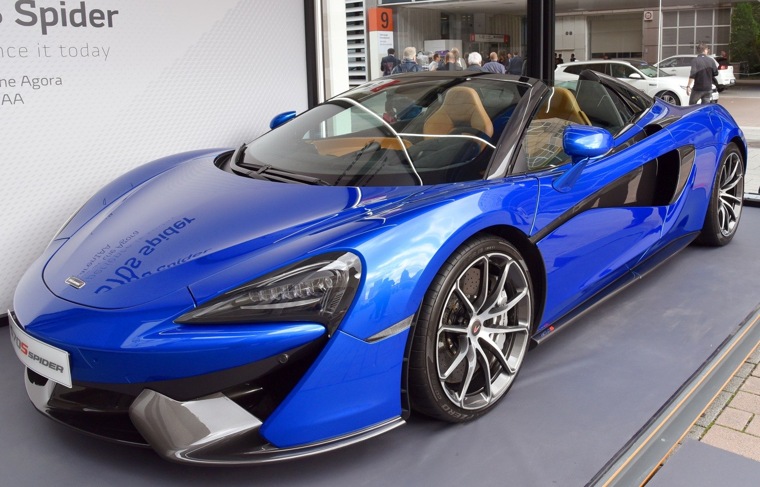 Blue aerodynamic convertible front close-up with detailed alloy wheels
