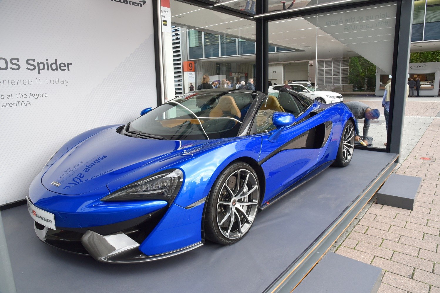 Blue convertible sports car with aerodynamic curves and alloy wheels