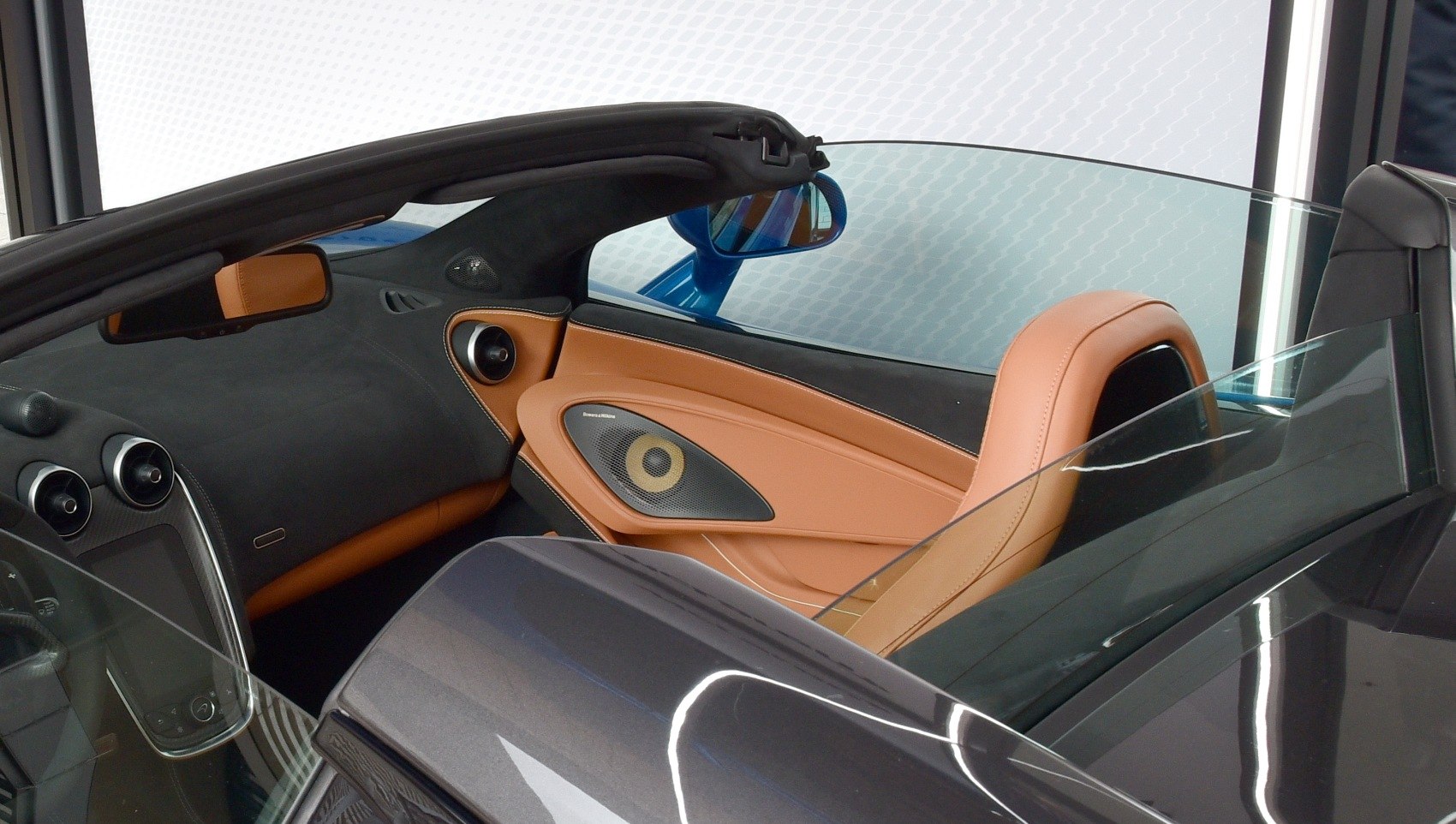 Tan leather seats with integrated premium speakers in convertible sports car interior