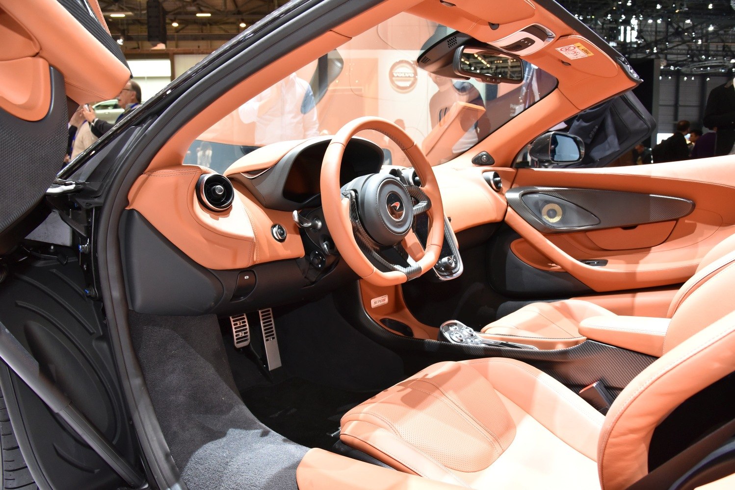 Tan leather interior with carbon fiber trim and sporty cockpit design