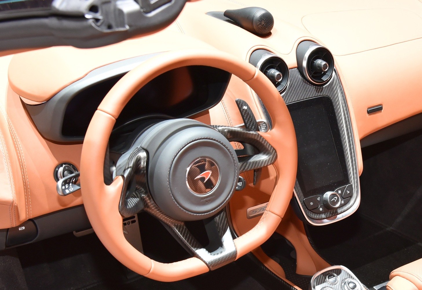 Luxury sports car interior with carbon fiber steering and center console