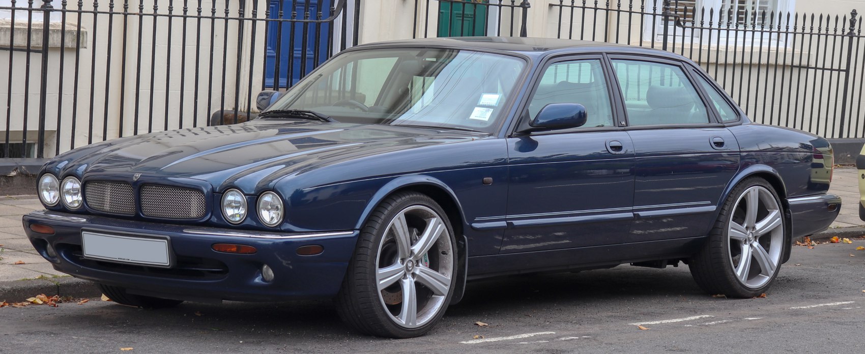 Quad round headlights and five-spoke alloy wheels on luxury sedan